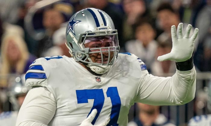 Oct 31, 2021; Minneapolis, Minnesota, USA; Dallas Cowboys offensive tackle La'el Collins (71) indicates he is an eligible receiver entering the game in the third quarter against the Minnesota Vikings at U.S. Bank Stadium. Mandatory Credit: Matt Blewett-USA TODAY Sports
